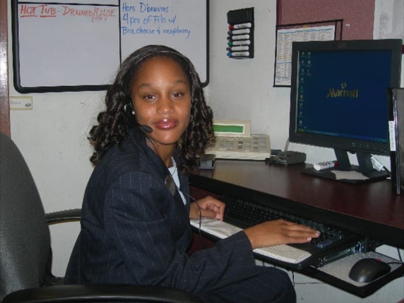 A Bridges participant working the front desk at a Marriott hotel