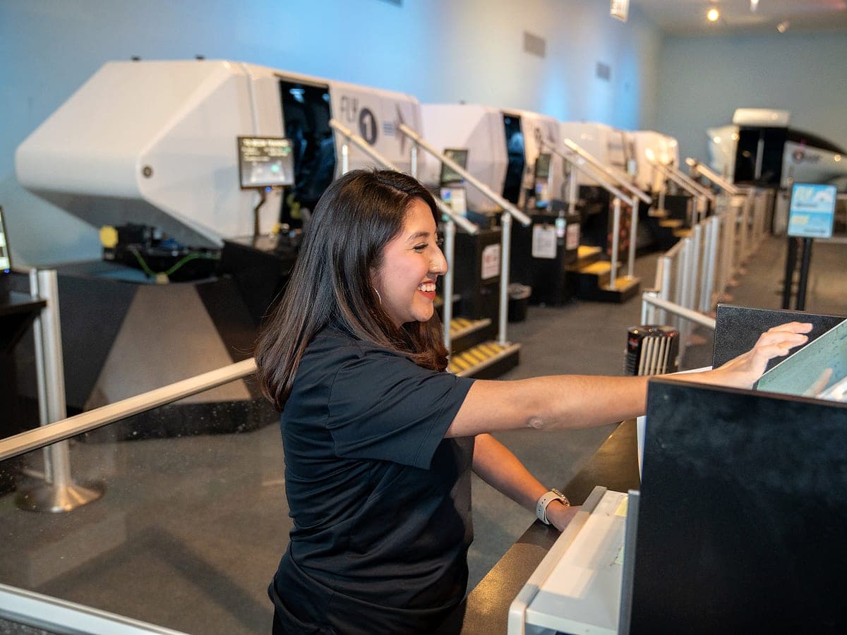 A Bridges participant operating a flight simulator station