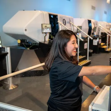 A Bridges participant operating a flight simulator station